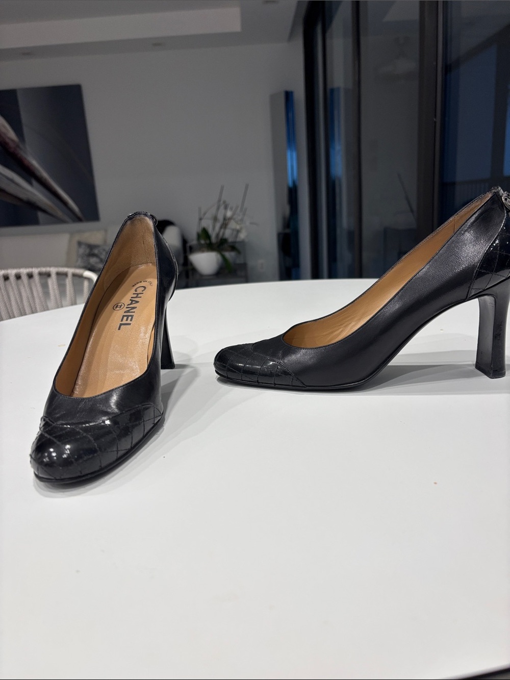 Vintage Chanel pumps Black leather/patent leather. Chanel logo on back of shoe.